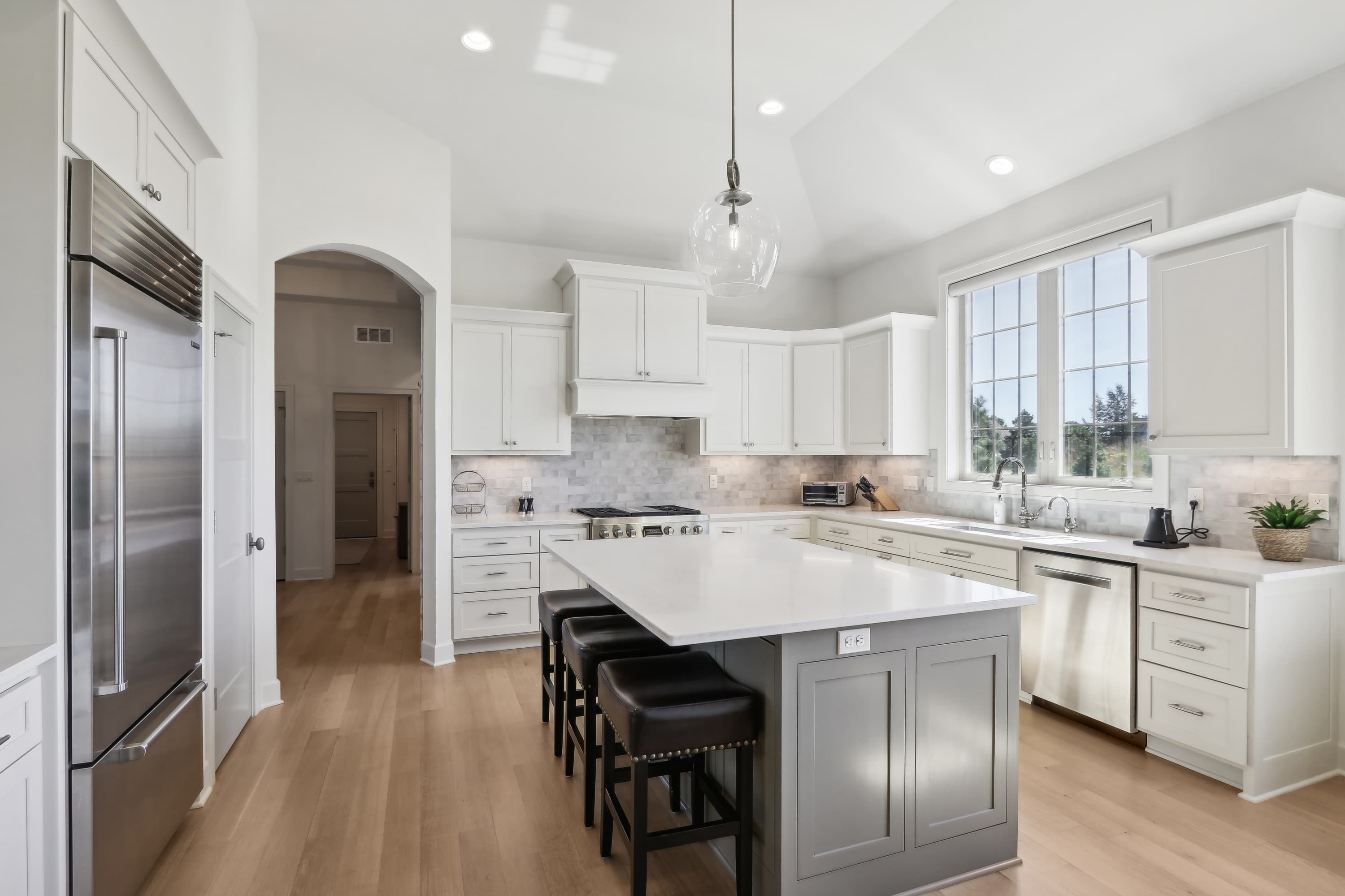 Refined kitchen with natural light and an oversized island